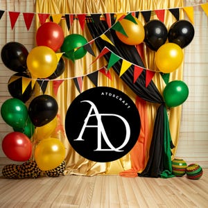 May include: A black circle with the text "ATDSCRAFT" and the letters "AD" in white. The circle is in front of a gold and black backdrop with red, green, and yellow balloons.