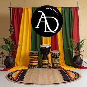May include: Three African djembe drums with black, red, and yellow designs, set against a backdrop of red, yellow, and green fabric. The fabric has the text "ATDSCRAFT" in white letters on a black circle.