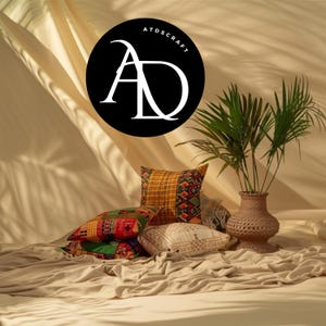 May include: A collection of decorative pillows in various patterns and colors, including red, green, yellow, and white. A woven vase holds a green plant. The image features the text "ATDSCRAFT" in a black circle.
