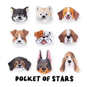 May include: Embroidered patches featuring various dog breeds, including a Shiba Inu, Beagle, and Bulldog. Each patch showcases detailed facial features and fur textures. The phrase "POCKET OF STARS" is printed in bold, black letters at the bottom.