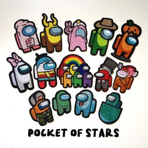 May include: A set of 15 colorful embroidered iron-on patches featuring characters from the popular video game Among Us. The patches are in various colors, including red, blue, green, yellow, pink, and black. The patches are all different shapes and sizes, and they feature different characters from the game, including the crewmate, the imposter, and the ghost. The patches are all iron-on, so they can be easily applied to clothing, bags, or other fabric items. The patches are perfect for adding a touch of fun and personality to any outfit. "Pocket of Stars" is written in black at the bottom of the image.