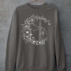 May include: A charcoal gray sweatshirt with a white floral design featuring a woman performing a pole dance.