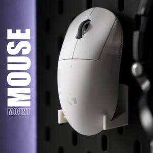 May include: A white computer mouse with a black scroll wheel and a white mount. The mouse has the text "SUPERLIGHT" printed on the side. The mount is attached to a black pegboard.