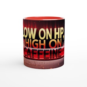 May include: Red coffee mug with a black background and the text "Low on HP, High on Caffeine" in yellow and red.