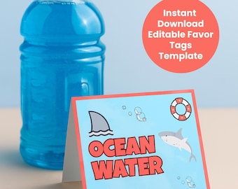 May include: A blue sports drink bottle next to a folded card with a shark theme. The card has a light blue background with a shark fin, a cartoon shark, and the words "OCEAN WATER" in red. A red circle with white text reads "Instant Download Editable Favor Tags Template."