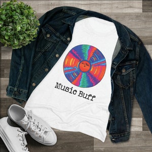 May include: White t-shirt with a colorful vinyl record graphic and the text "Music Buff" printed on it.