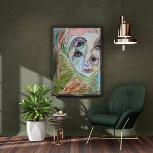 May include: A framed abstract drawing of a face with colorful lines and shapes. The drawing is in a black frame and is hanging on a green wall. The wall is textured and has a light green color. There is a green armchair in the foreground and a small table with a bowl of fruit on it.