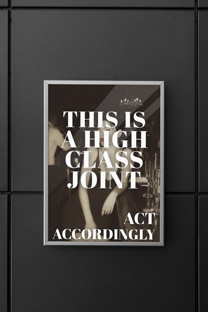 May include: Framed print with a sepia-toned image of a woman in a bar setting. The print features the text "THIS IS A HIGH CLASS JOINT ACT ACCORDINGLY" in bold white letters. The print is displayed on a black wall.