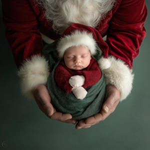 May include: A sleeping newborn baby wrapped in a dark green blanket and a red outfit, wearing a Santa hat. The baby is held in hands wearing a red Santa suit with white fur trim. The background is a muted green.
