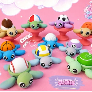 May include: A collection of turtle-shaped clicker toys, each featuring a different sports ball on its back, including a football, soccer ball, basketball, volleyball, baseball, and billiard ball, set against a pink background with text.