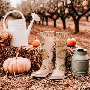 May include: A pair of white rain boots with a colorful floral pattern, pumpkins, and a watering can in a hay bale setting.  Digital Mockup PSD smart object for Photoshop.
