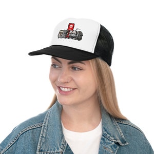 May include: A black and white trucker hat with a white front panel featuring a cartoon illustration of a group of characters with the text "The Bad Batch". The hat has a black mesh back panel.