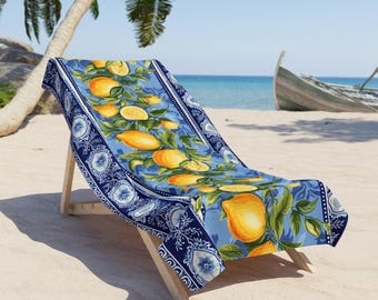May include: A blue and white beach chair with a lemon print. The chair is made of wood and has a blue and white patterned fabric with lemons and green leaves.