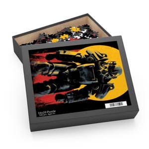 May include: A black puzzle box with a graphic of a futuristic vehicle against a yellow and red background. The box is labeled "16x20 Puzzle" and "500 pcs Ages 9+". The box is open, revealing puzzle pieces.