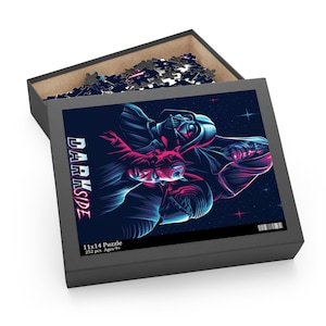 May include: A 252-piece jigsaw puzzle featuring a dark blue background with a neon pink and blue illustration of Darth Vader, Kylo Ren, and Darth Maul. The text "DARK SIDE" is written vertically on the left side of the image. The puzzle is for ages 9 and up.