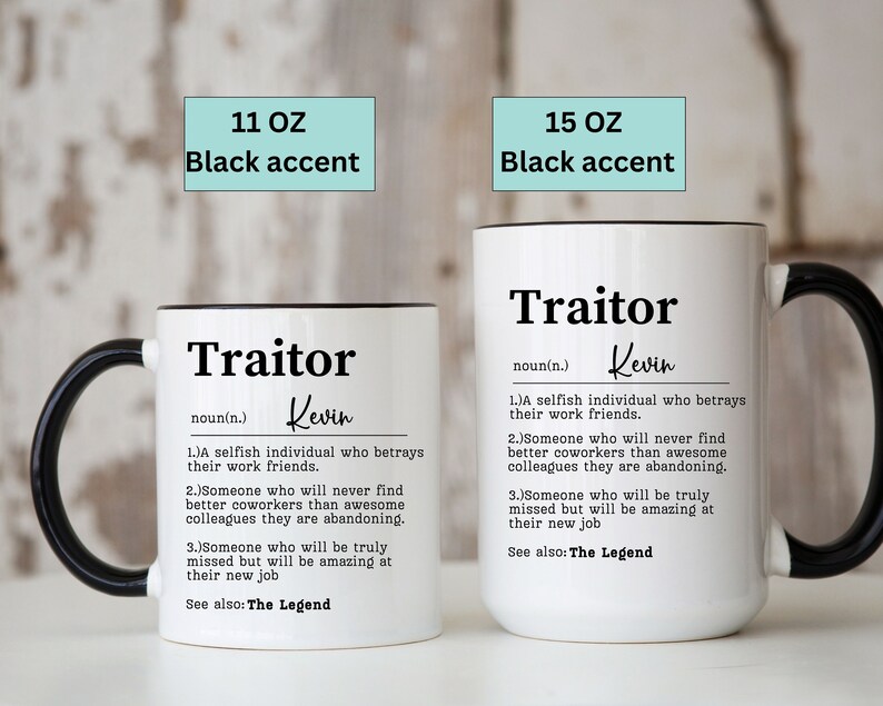 May include: Two white ceramic mugs with black handles and black rims. The mugs have a definition of the word "Traitor" with the name "Kevin" written in cursive. The mugs are available in 11 oz and 15 oz sizes.