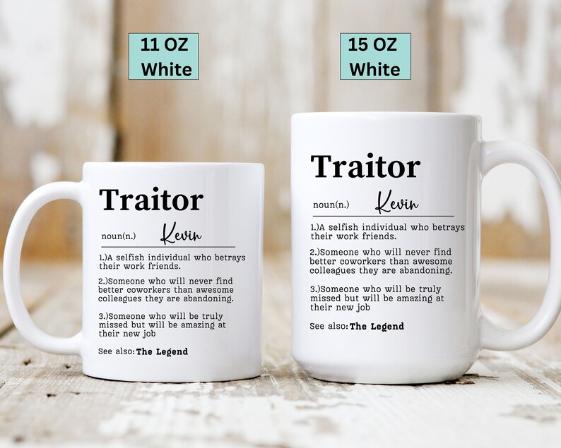 May include: Two white ceramic mugs with a humorous definition of the word "Traitor" printed on them. The mugs are available in 11 oz and 15 oz sizes.
