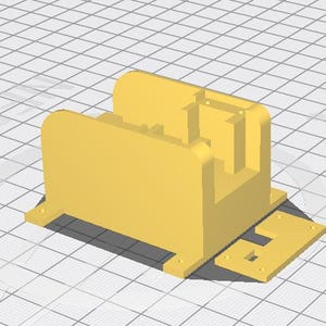 Könnte beinhalten: Ein 3D-gerendertes Modell eines gelben, rechteckigen Objekts mit abgerundeten Kanten und einer flachen Basis. Das Objekt hat einen zentralen Hohlraum und ein separates, kleineres rechteckiges Teil, das an der Basis befestigt ist.