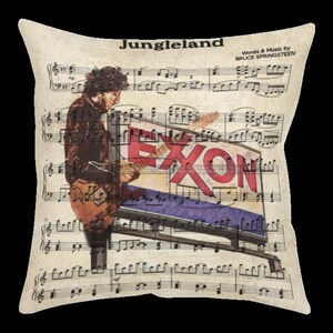 May include: Square pillow featuring a vintage-style design with sheet music and a musician playing a guitar. The word "Jungleland" is at the top, with "Words & Music by Bruce Springsteen" below it. The Exxon sign is in the center.