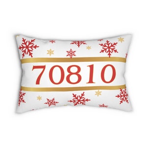 May include: White pillow with a red and gold snowflake pattern and the number 70810 in red.
