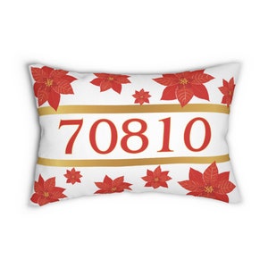 May include: White pillow with a red poinsettia pattern and gold stripes. The number 70810 is printed in red on the pillow.