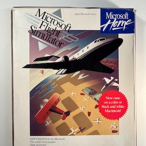 May include: Microsoft Flight Simulator box art featuring a black jet and red biplane flying over a landscape with small white airplanes. The box has the Microsoft Home logo and text that reads "Now runs on a color or black and white Macintosh!"