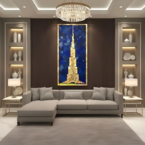May include: A modern living room featuring a large abstract painting of a gold and blue skyscraper. A gray sectional sofa sits on a gray rug. Two side tables with lamps and decorative shelves flank the sofa.