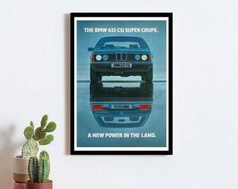 May include: A vintage print advertisement for the BMW 633 CSI Super Coupe. The ad features a blue car with a black bumper and a black license plate that reads "BMW 633 CSI". The car is reflected in the water below. The text reads "THE BMW 633 CSI SUPER COUPE. A NEW POWER IN THE LAND."