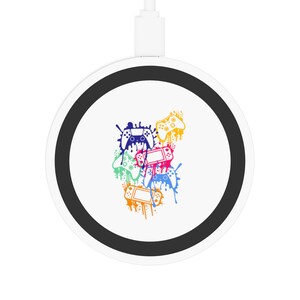 May include: A white wireless charging pad with a black ring around the edge. The charging pad features a colorful design of video game controllers with paint splatters.