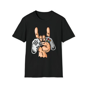 May include: Black t-shirt with a graphic of a hand holding a video game controller and making the rock and roll hand gesture.