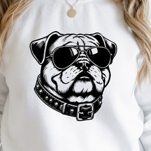May include: White sweatshirt with a black and white illustration of a pug wearing sunglasses and a studded collar.