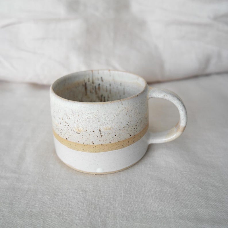Rustic brown and white ceramic mug, handmade pottery gift, crafted with natural clay for a cozy coffee experience.