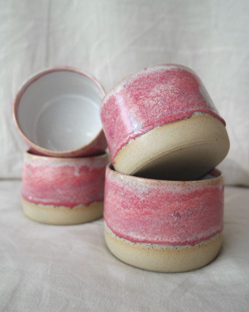 Handmade ceramic cup in a pink glaze, smooth to the touch with subtle lava patterning. Wheel thrown pottery mug without a handle, crafted in Australia. Perfect ceramic drinkware gift for coffee or tea.