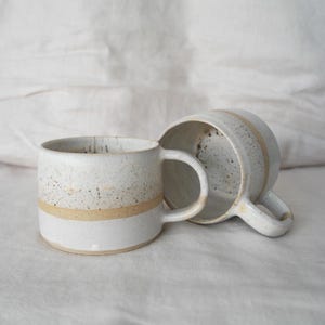 Rustic handmade ceramic coffee mug, earthy tones, crafted with care using Australian clay for a cozy home vibe.