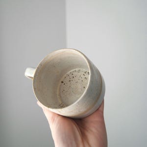 Artisan wheel thrown coffee mug, handmade with Australian clay, featuring a unique rustic design.