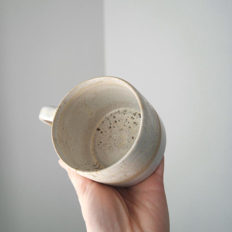 Artisan wheel thrown coffee mug, handmade with Australian clay, featuring a unique rustic design.
