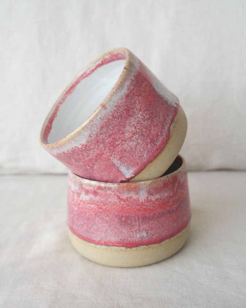 Pink pottery tea cup with glossy glaze finish. Wheel thrown ceramic handleless mug, dishwasher safe, food safe and gift wrapped. Artisan handmade pottery cup perfect for gifting or everyday use.
