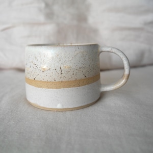 Earthy-toned stoneware mug, wheel thrown and handcrafted, showcasing Australian clay's natural beauty.