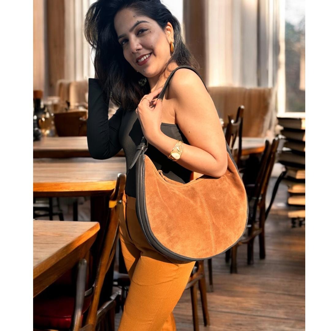 Suede shoulder bag with metal logo on the front
