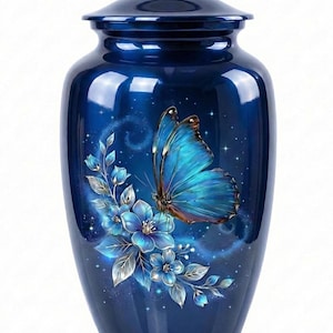 Puede incluir: Una urna azul oscuro con acabado brillante. Está decorada con una gran mariposa azul y flores azules. La mariposa tiene alas detalladas con tonos de azul y marrón. Las flores tienen hojas plateadas sobre un fondo estrellado.