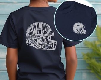 May include: Navy blue youth t-shirt featuring a white graphic of a football helmet with a cross on top. The graphic includes the text "I can do all things thru Christ who strengthens me. Philippians 4:13"