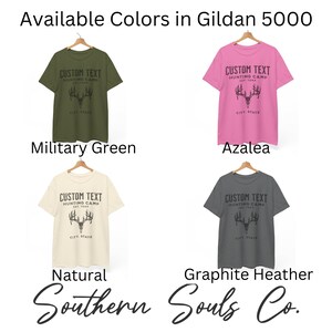 May include: Four Gildan 5000 t-shirts in different colors: military green, azalea, natural, and graphite heather. Each shirt features a black and white graphic of a deer head with the text "CUSTOM TEXT HUNTING CAMP EST. YEAR CITY STATE".