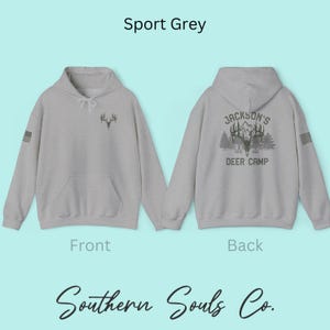 May include: Sport Grey hoodie with a front deer antler graphic and a back graphic that reads "Jackson's Deer Camp Est. 1984". The hoodie has a front pocket and a small American flag on the sleeve. The brand name "Southern Souls Co." is at the bottom.
