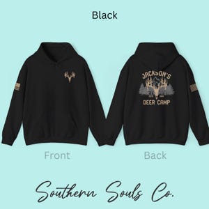 May include: Black hoodie with a front chest design of a deer antler and a back design that reads "Jackson's Deer Camp Est. 1964". The hoodie has a kangaroo pocket and a hood. The text "Southern Souls Co." is at the bottom.