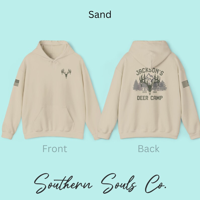 May include: Sand-colored hoodie with a front pocket and hood. The front features a deer antler graphic, and the back displays "Jackson's Deer Camp" with a deer and tree design. The text "Southern Souls Co." is at the bottom.