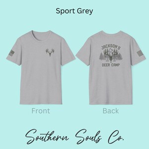 May include: Sport grey t-shirts with front and back designs. The front features a small antler graphic and a US flag on the sleeve. The back displays "Jackson's Deer Camp" with a deer head and mountain scene. The brand name "Southern Souls Co." is at the bottom.