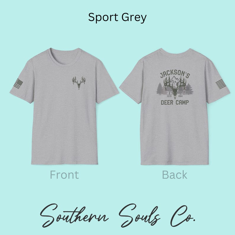May include: Sport grey t-shirts with front and back designs. The front features a small antler graphic and a US flag on the sleeve. The back displays "Jackson's Deer Camp" with a deer head and mountain scene. The brand name "Southern Souls Co." is at the bottom.