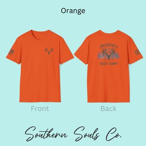 May include: Orange t-shirt with a deer antler graphic on the front and the text "Jackson's Deer Camp" on the back. The shirt also features a small American flag design on the sleeve. The text "Southern Souls Co." is at the bottom.