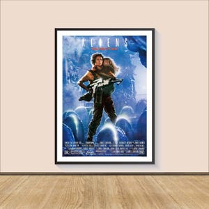 May include: A movie poster for the film "Aliens" featuring a blue and black background with a woman holding a gun and a child. The text "ALIENS" is in red and white letters.