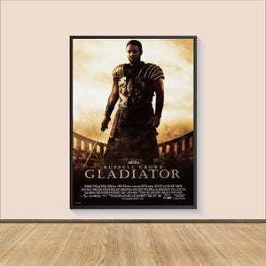 May include: A movie poster for the film "Gladiator" featuring Russell Crowe as Maximus Decimus Meridius, a Roman general who is betrayed and forced into slavery. The poster features a dramatic image of Crowe in character, standing in a gladiatorial arena, with a sword in his hand. The title of the film is prominently displayed in large, bold letters.